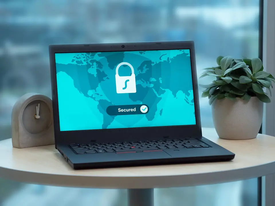 Laptop on a table showing a padlock security screen