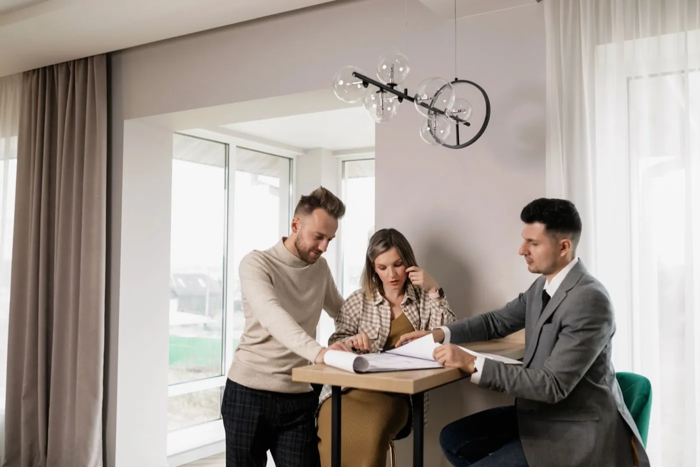 Real estate agent going over closing papers with a couple